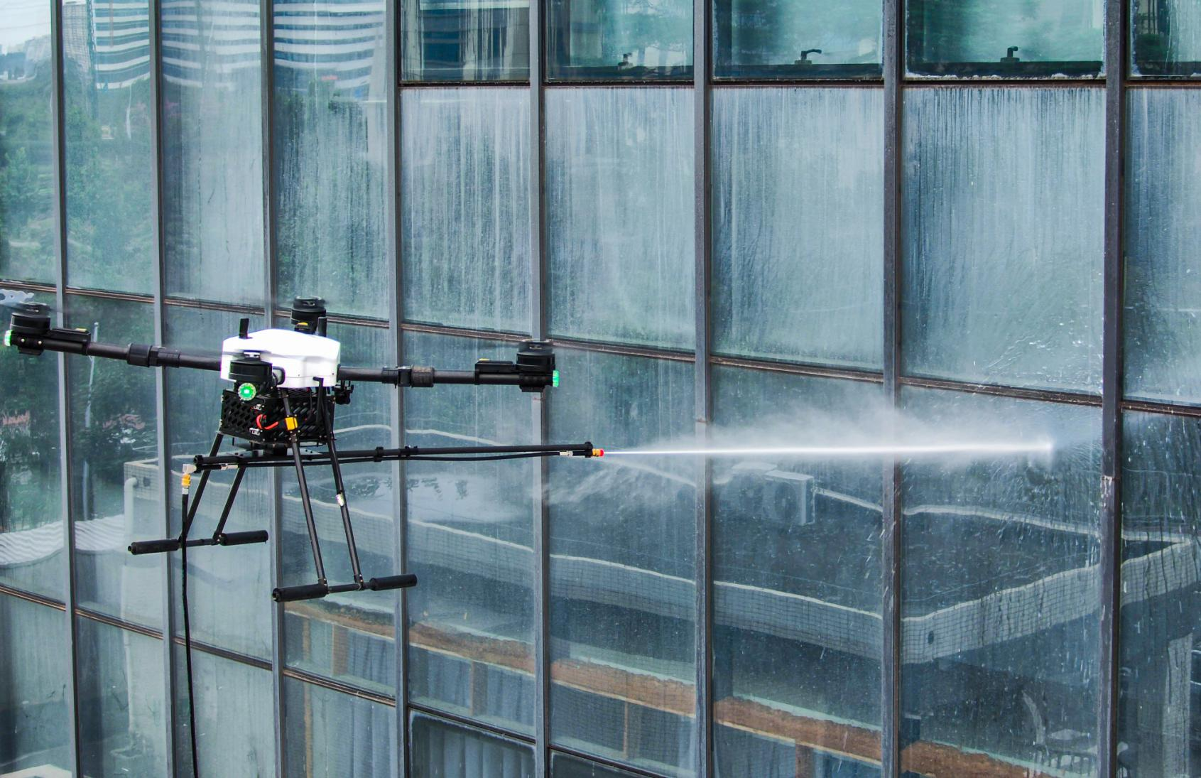 Drone washing the exterior of a glazed building